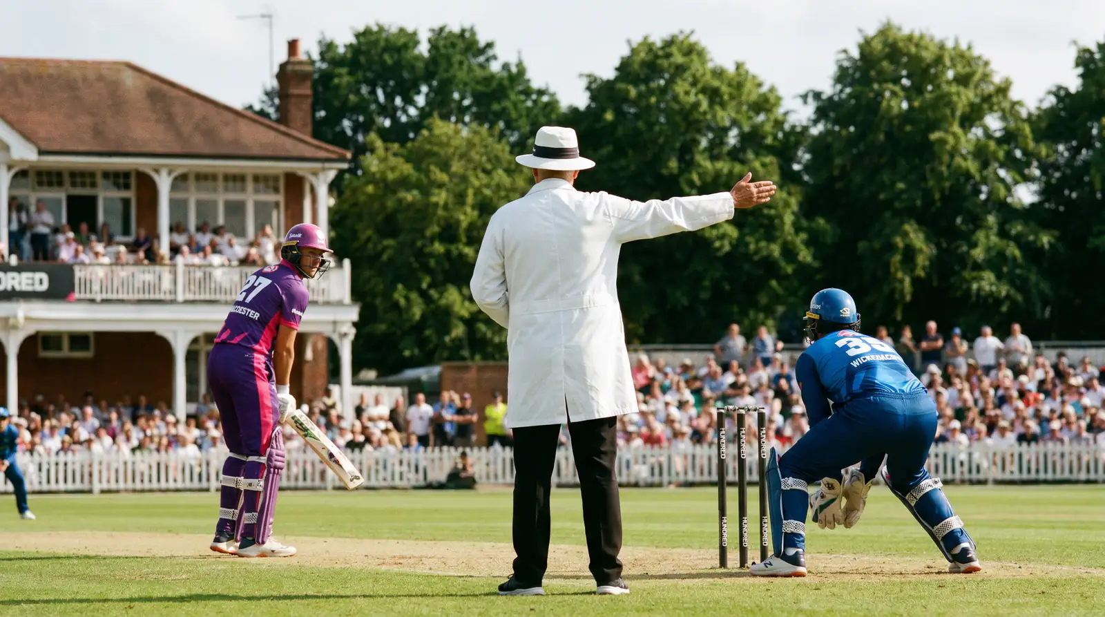 Umpire signals the end of a five-ball set during a Hundred match at an English ground