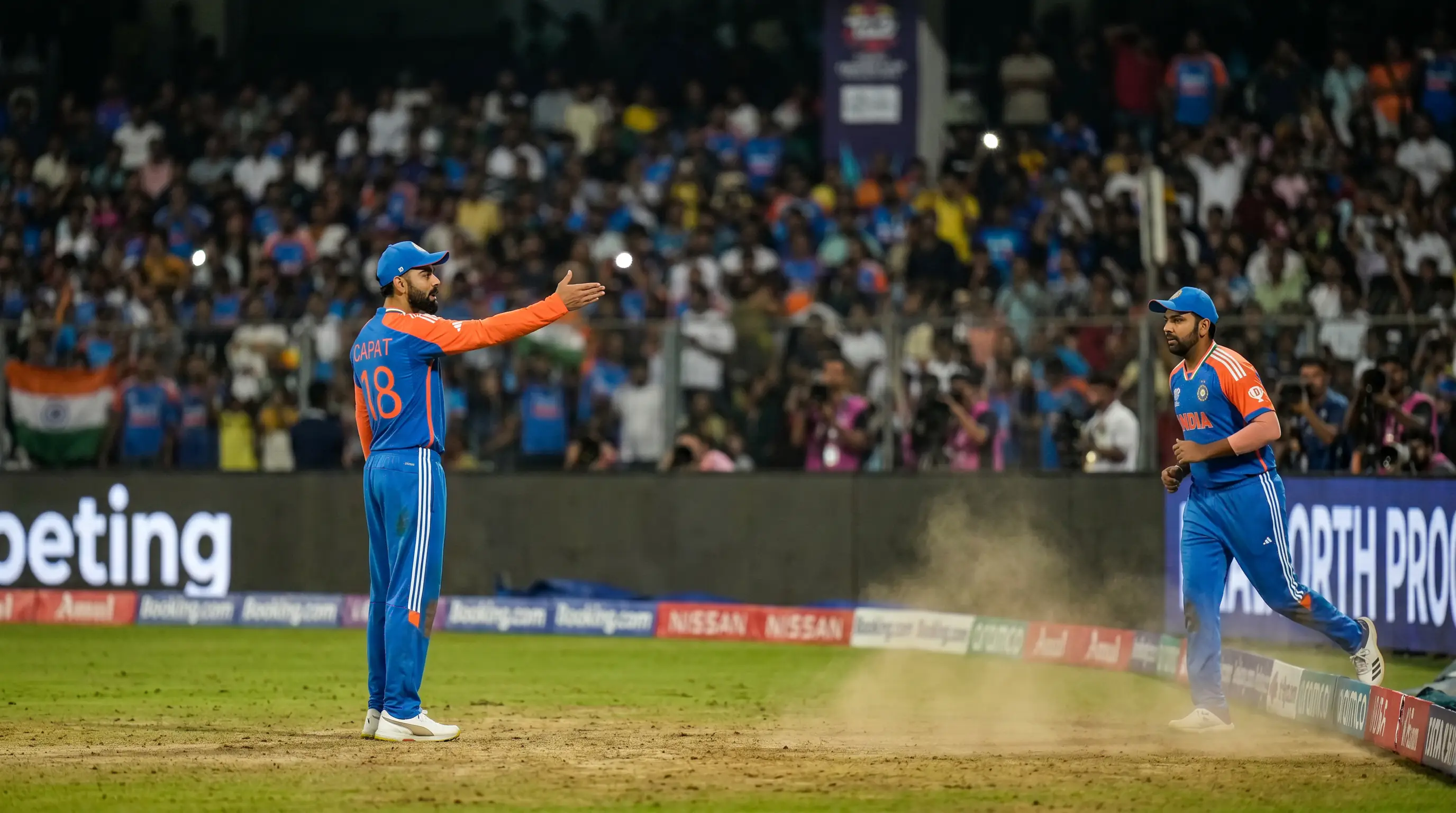 T20 captain signals a fielding change to a fielder near the boundary mid-over