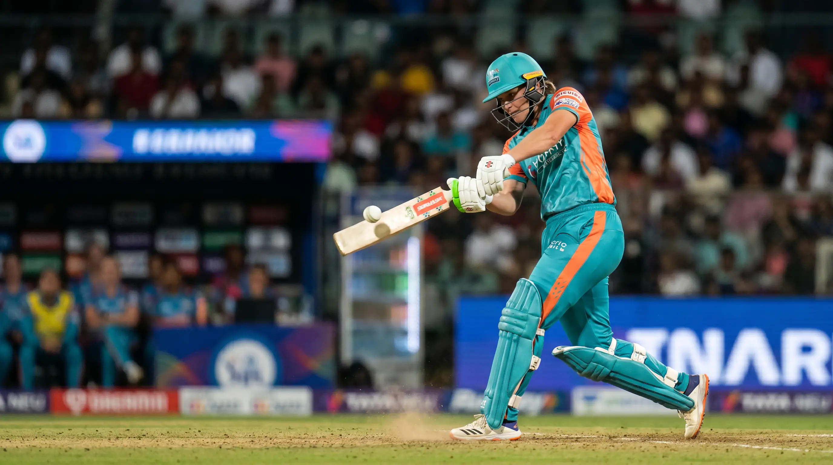 Women's international cricket batter playing a pull shot to the leg-side during a day-night limited-overs match
